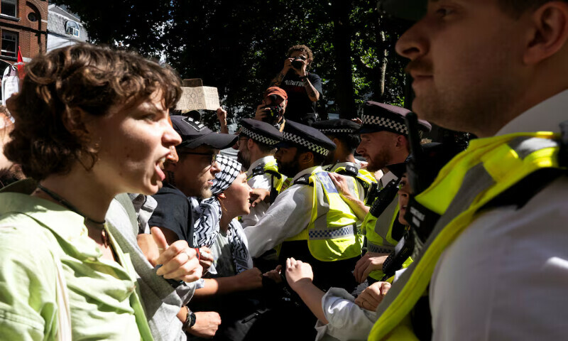 Supporters of the pro-Palestinian group Palestine Action scuffle with police officers outside the High Court in London. – Reuters