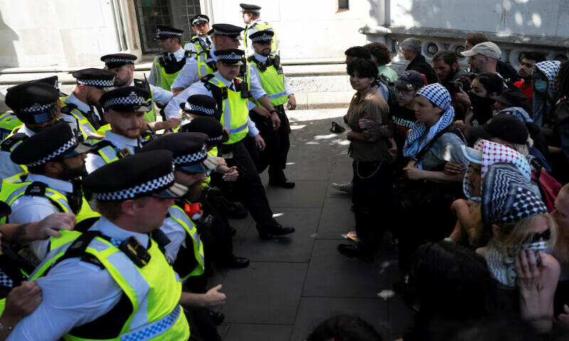 Supporters of the pro-Palestinian group Palestine Action scuffle with police in London. – Reuters