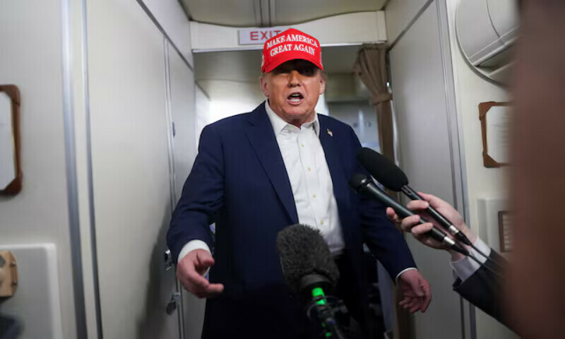 US President Donald Trump speaks to members of the media on board Air Force One on the way to New Jersey, US. – Reuters