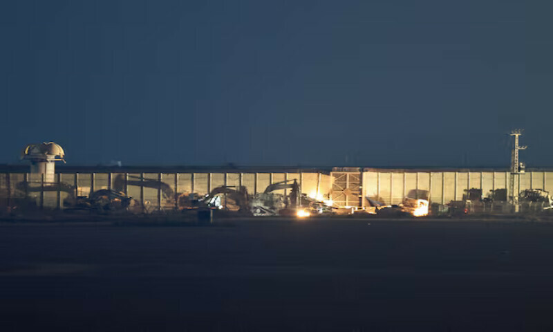 Military vehicles stand in position on the Israeli side of the Israel-Gaza border. – Reuters