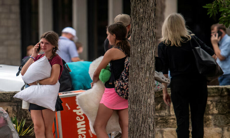 A girl speaks on the phone in an area where families were being reunited with campers after deadly flooding in Kerville, Texas. – Reuters
