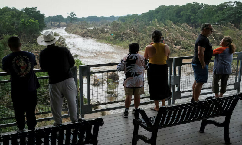 People look at the Guadalupe river, following flash flooding, as they gather after receiving a SMS alerting on potential floods in the area, in Kerrville, Texas. – Reuters People look at the Guadalupe river, following flash flooding, as they gather after receiving a SMS alerting on potential floods in the area, in Kerrville, Texas. – Reuters