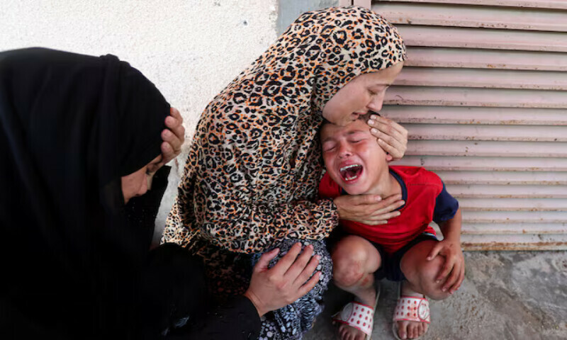 A Palestinian woman comforts a child as casualties are brought into Al Aqsa Martyrs Hospital following an Israeli strike in Deir Al Balah, central Gaza Strip on Thursday. – Reuters A Palestinian woman comforts a child as casualties are brought into Al Aqsa Martyrs Hospital following an Israeli strike in Deir Al Balah, central Gaza Strip on Thursday. – Reuters