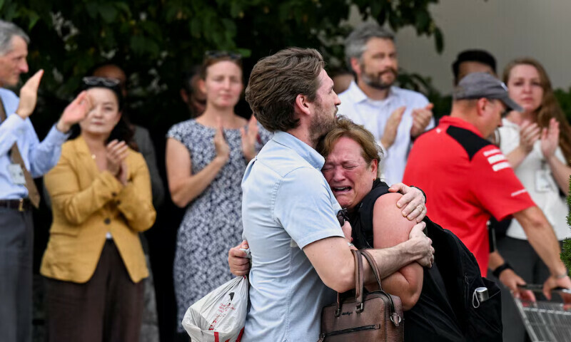 A man comforts a woman as she cries while people applaud in the background during a sendoff event for US State Department workers in Washington, DC. – Reuters A man comforts a woman as she cries while people applaud in the background during a sendoff event for US State Department workers in Washington, DC. – Reuters