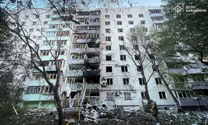 Firefighters and a police officer work at the site of an apartment building damaged during Russian drone and missile strikes in Chernivtsi, Ukraine, on Saturday. – Reuters