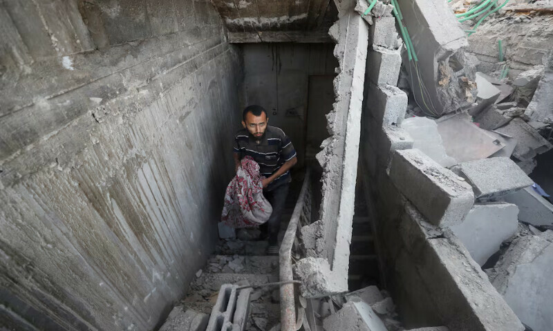 A Palestinian inspects the site of an Israeli strike on a house in Gaza City on Sunday. – Reuters A Palestinian inspects the site of an Israeli strike on a house in Gaza City on Sunday. – Reuters