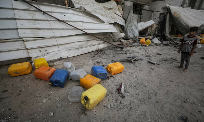 A Palestinian boy inspects the site of an Israeli strike that killed Palestinians gathered to collect water from a distribution point in Nuseirat in the central Gaza Strip on Sunday. – Reuters A Palestinian boy inspects the site of an Israeli strike that killed Palestinians gathered to collect water from a distribution point in Nuseirat in the central Gaza Strip on Sunday. – Reuters