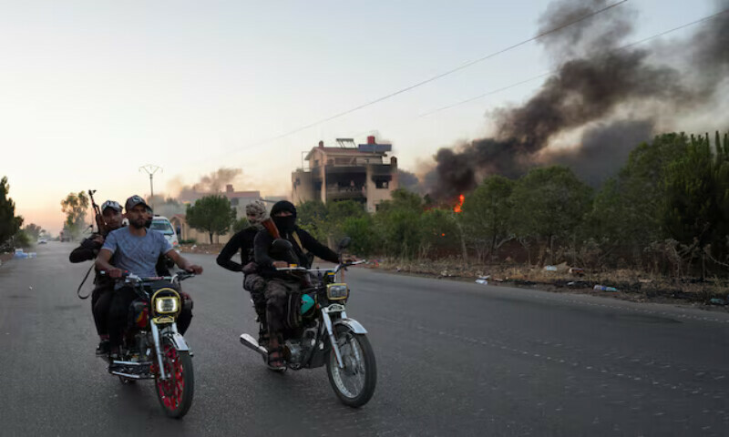 Bedouin fighters ride on motorbikes along a street at the Sweida governorate in Syria. – Reuters Bedouin fighters ride on motorbikes along a street at the Sweida governorate in Syria. – Reuters