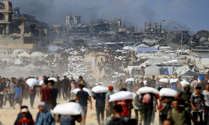 Palestinians carry aid supplies amid a hunger crisis in Beit Lahia in the northern Gaza Strip on Sundayu. – Reuters Palestinians carry aid supplies amid a hunger crisis in Beit Lahia in the northern Gaza Strip on Sundayu. – Reuters