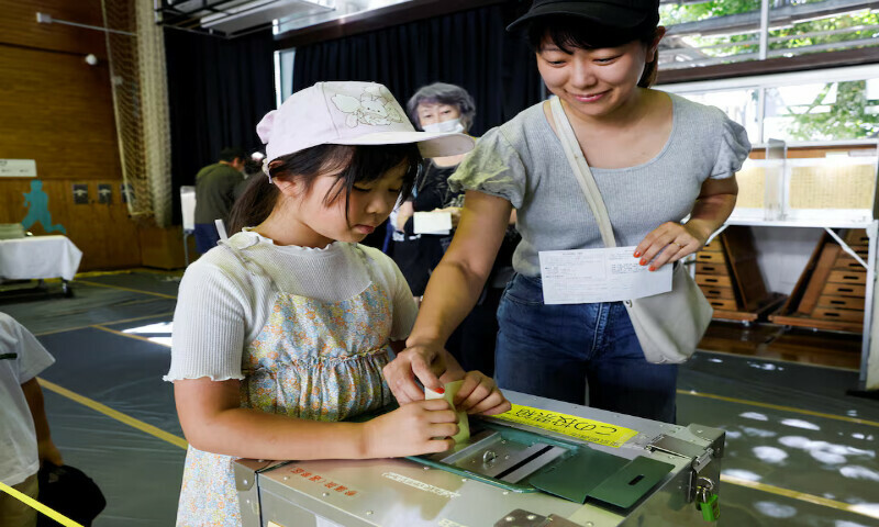 A girl tries to cast her mother’s ballot with her help at a polling station in Tokyo, Japan, on Sunday. – Reuters A girl tries to cast her mother’s ballot with her help at a polling station in Tokyo, Japan, on Sunday. – Reuters