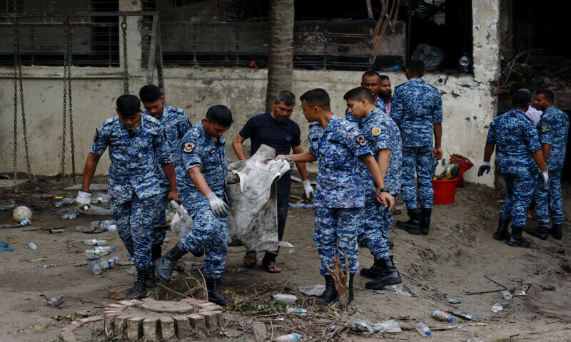 Members of Bangladesh Air Force work at the plane crash site in Dhaka, Bangladesh, on Tuesday. – Reuters Members of Bangladesh Air Force work at the plane crash site in Dhaka, Bangladesh, on Tuesday. – Reuters