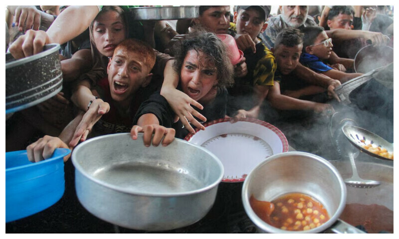 Palestinians gather to receive food cooked by a charity kitchen, amid the Israel-Hamas conflict, in the northern Gaza Strip, September 11, 2024. REUTERS Palestinians gather to receive food cooked by a charity kitchen, amid the Israel-Hamas conflict, in the northern Gaza Strip, September 11, 2024. REUTERS