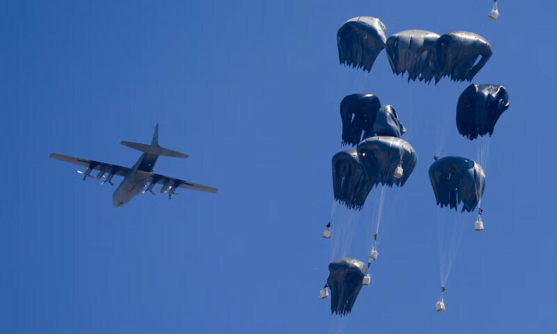 An aeroplane drops humanitarian aid over Gaza as seen from the northern Gaza Strip on Sunday. – Reuters