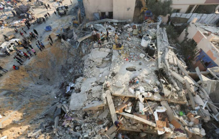 Palestinians gather at the site of an overnight Israeli air strike on a house, in Khan Younis in the southern Gaza Strip, July 28, 2025. REUTERS