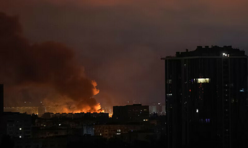 Fire and smoke are seen in the city after a Russian drone strike in Kyiv, Ukraine, on Thursday. – Reuters