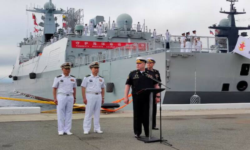 Russian and Chinese naval officers take part in a ceremony marking the start of the upcoming joint naval drills in the Sea of Japan. — Reuters Russian and Chinese naval officers take part in a ceremony marking the start of the upcoming joint naval drills in the Sea of Japan. — Reuters