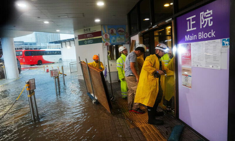 Workers place a blockade outside the flooded accident and emergency department of a hospital in Hong Kong, China, on Tuesday. – Reuters