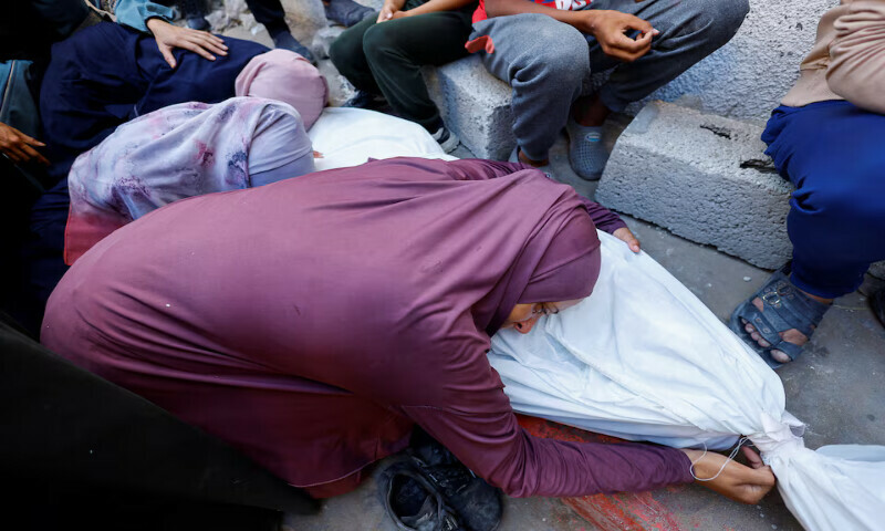 The mother of a Palestinian who was killed by Israeli fire while trying to receive aid mourns over his body during his funeral at Al Shifa Hospital in Gaza City. – Reuters The mother of a Palestinian who was killed by Israeli fire while trying to receive aid mourns over his body during his funeral at Al Shifa Hospital in Gaza City. – Reuters