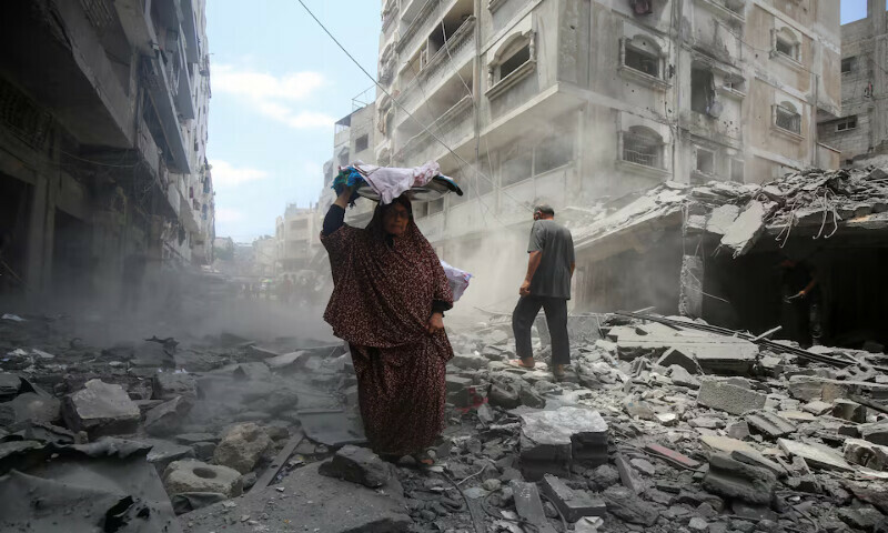 Palestinians inspect the site of an Israeli strike on a house in Gaza City. – Reuters Palestinians inspect the site of an Israeli strike on a house in Gaza City. – Reuters