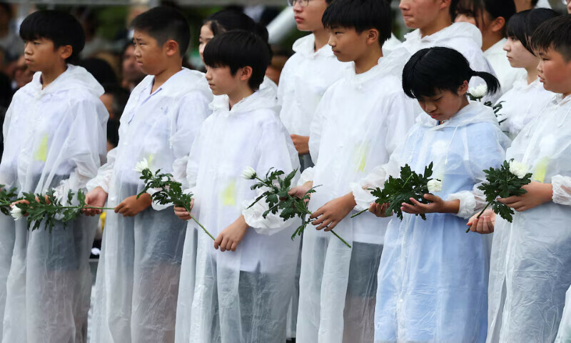 Children hold flowers during a ceremony commemorating the 80th anniversary of the atomic bombing of Nagasaki at city’s Peace Park on Saturday. – Reuters Children hold flowers during a ceremony commemorating the 80th anniversary of the atomic bombing of Nagasaki at city’s Peace Park on Saturday. – Reuters