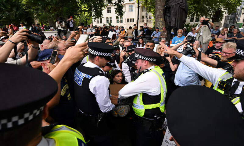 Police officers detain a demonstrator during a rally organised by Defend Our Juries, challenging the British government’s proscription of “Palestine Action” under anti-terrorism laws, in Parliament Square, in London. – Reuters Police officers detain a demonstrator during a rally organised by Defend Our Juries, challenging the British government’s proscription of “Palestine Action” under anti-terrorism laws, in Parliament Square, in London. – Reuters