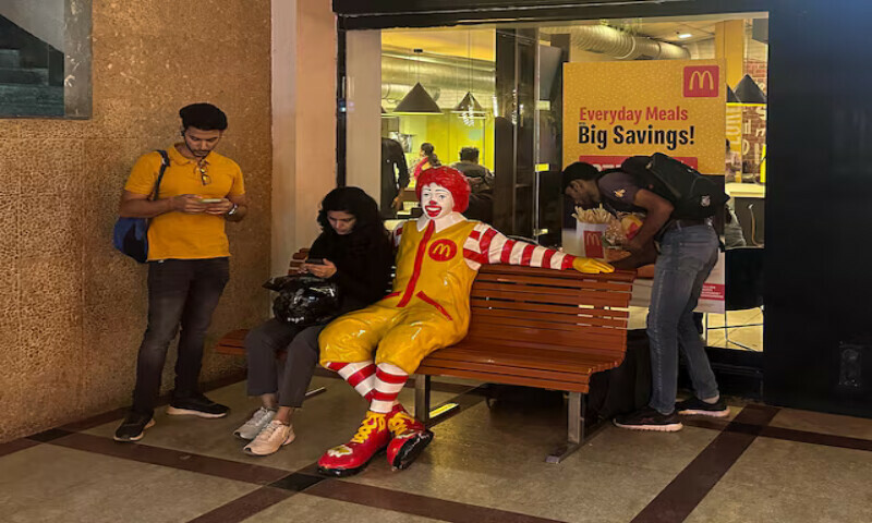 A person sits outside a McDonald’s restaurant in Mumbai, India. – Reuters A person sits outside a McDonald’s restaurant in Mumbai, India. – Reuters