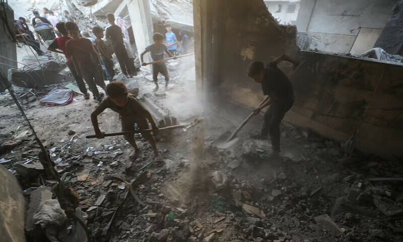 Children shovel the dirt as Palestinians look for casualties amid the damage at the site of an Israeli strike on a house at Shati refugee camp in Gaza City. – Reuters file Children shovel the dirt as Palestinians look for casualties amid the damage at the site of an Israeli strike on a house at Shati refugee camp in Gaza City. – Reuters file