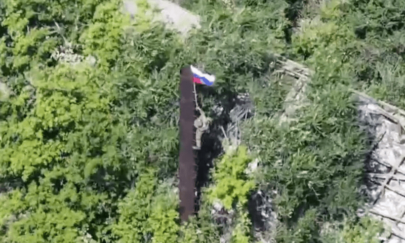 A still image, taken from footage released by the Russian Defence Ministry, shows what it said to be a Russian soldier raising a flag following the capture of Ukraine’s Yablunivka (Yablonovka) settlement in the Donetsk region in the course of Russia-Ukraine military conflict, in this image from video released on August 12, 2025. Reuters A still image, taken from footage released by the Russian Defence Ministry, shows what it said to be a Russian soldier raising a flag following the capture of Ukraine’s Yablunivka (Yablonovka) settlement in the Donetsk region in the course of Russia-Ukraine military conflict, in this image from video released on August 12, 2025. Reuters