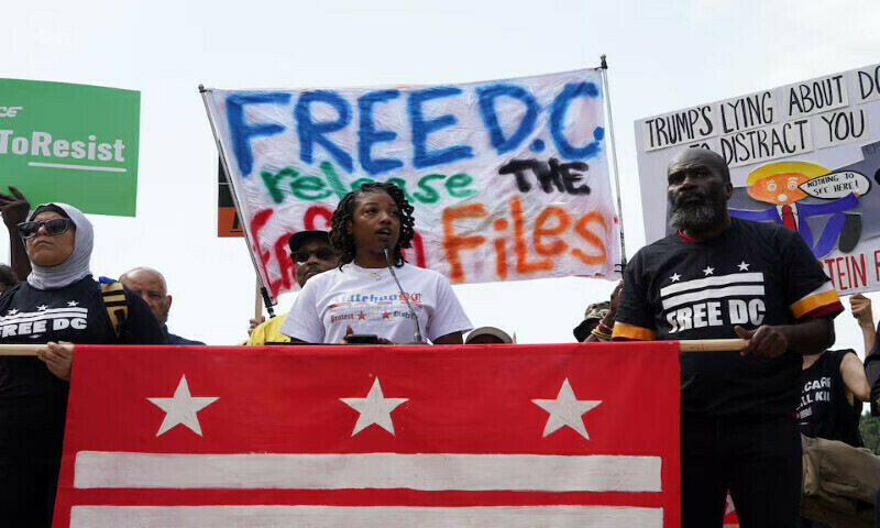 A demonstrator speaks during a protest near the White House in Washington DC. – Reuters A demonstrator speaks during a protest near the White House in Washington DC. – Reuters