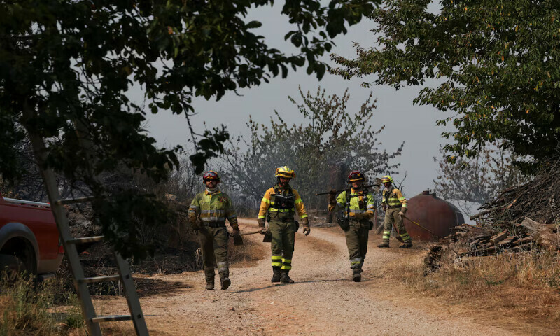 Firefighters look for flare-ups in the village of Orellan in the aftermath of a wildfire in the region, Spain. – Reuters Firefighters look for flare-ups in the village of Orellan in the aftermath of a wildfire in the region, Spain. – Reuters