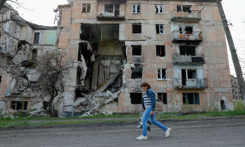 A woman walks past a residential building destroyed in the course of the Russia-Ukraine conflict in Toshkivka in the Luhansk region, Ukraine. – Reuters file A woman walks past a residential building destroyed in the course of the Russia-Ukraine conflict in Toshkivka in the Luhansk region, Ukraine. – Reuters file