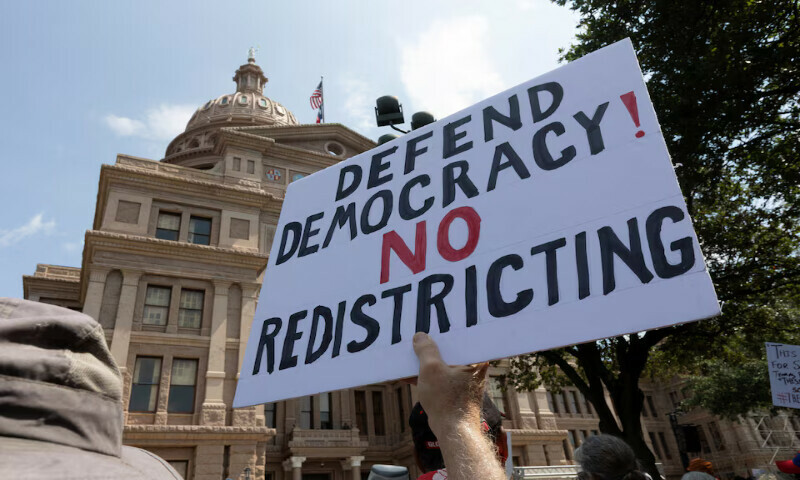 A protester raises a sign during one of the Fight the Trump Takeover rallies in Austin, Texas, US. – Reuters A protester raises a sign during one of the Fight the Trump Takeover rallies in Austin, Texas, US. – Reuters