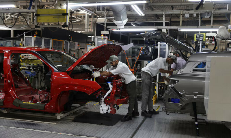 Employees assemble different parts onto a car panel at the manufacturing plant of Maruti Suzuki in Manesar, in the northern state of Haryana, India. – Reuters file