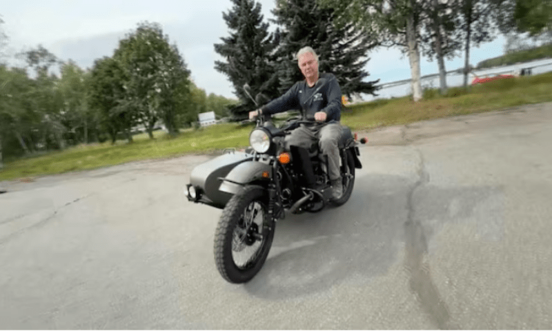 Alaska resident Mark Warren rides his new Ural motorcycle, a gift from Russian President Vladimir Putin, handed over by a Russian Embassy official, in Anchorage, Alaska, US, in this still image from video released on August 18, 2025. Reuters