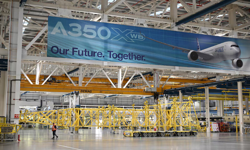 A worker walks on the Airbus A350 wing manufacturing floor at the Airbus Broughton plant in Chester, north Wales, Britain. – Reuters file