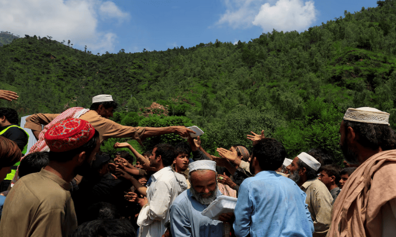 Residents gather to receive the food handouts, following a storm that caused heavy rains and flooding in Qadir Nagar area, in Buner district on August 21 2025. Reuters file Residents gather to receive the food handouts, following a storm that caused heavy rains and flooding in Qadir Nagar area, in Buner district on August 21 2025. Reuters file