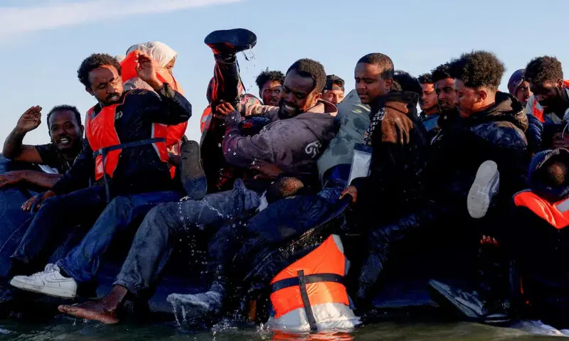 A group of migrants board an inflatable dinghy before leaving the coast of northern France in an attempt to cross the English Channel to reach Britain, from the beach of Petit-Fort-Philippe in Gravelines, near Calais, France, August 25, 2025. REUTERS A group of migrants board an inflatable dinghy before leaving the coast of northern France in an attempt to cross the English Channel to reach Britain, from the beach of Petit-Fort-Philippe in Gravelines, near Calais, France, August 25, 2025. REUTERS