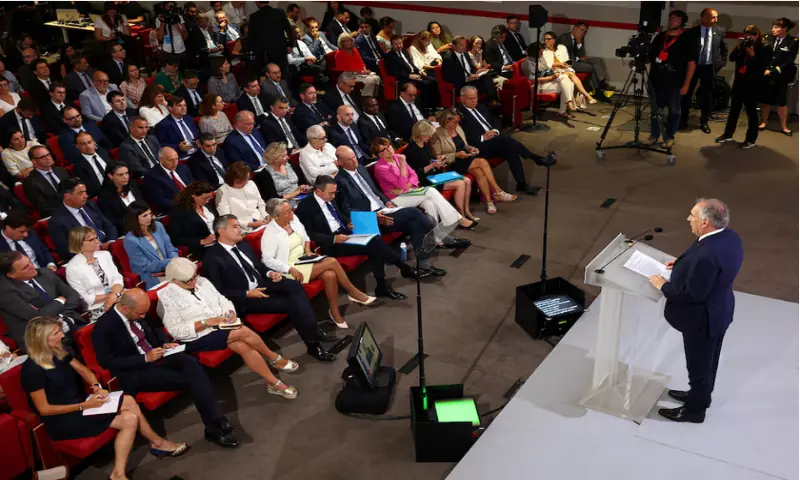 French Prime Minister Francois Bayrou delivers a speech as members of the French government listen to him during a press conference about his 2026 budget in Paris, on August 25, 2025.