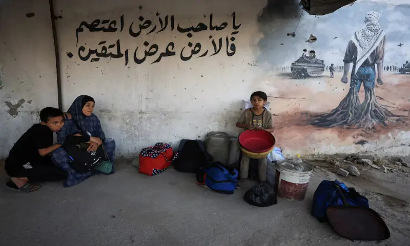A displaced Palestinian family sits on the ground outside Al Ahli Arab Hospital after fleeing Israeli strikes in Gaza City on Tuesday. – Reuters A displaced Palestinian family sits on the ground outside Al Ahli Arab Hospital after fleeing Israeli strikes in Gaza City on Tuesday. – Reuters