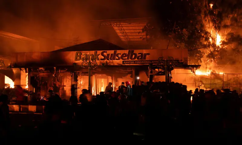Protesters gather near a building burning within the premises of the regional parliament in Makassar, South Sulawesi province, Indonesia. – Reuters Protesters gather near a building burning within the premises of the regional parliament in Makassar, South Sulawesi province, Indonesia. – Reuters
