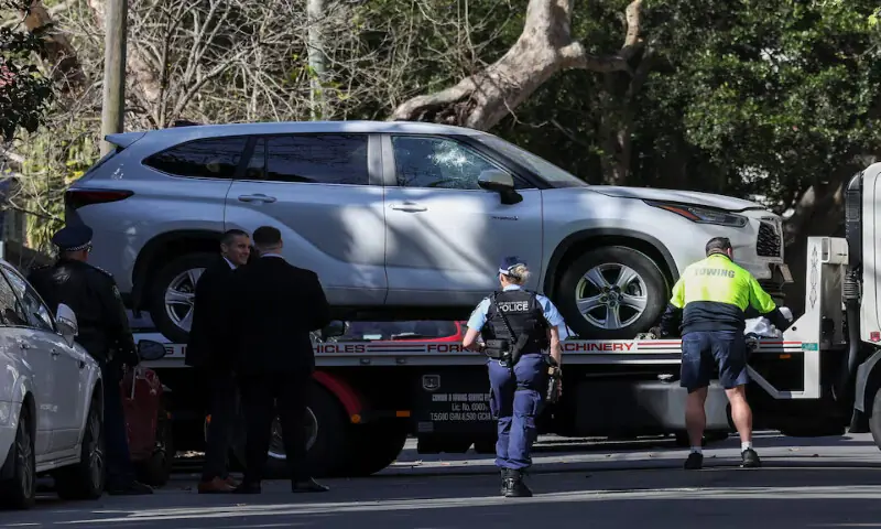 Police officers oversee the loading of a car with a smashed window onto a flatbed truck after it crashed into the Russian consulate in Sydney, Australia. – Reuters Police officers oversee the loading of a car with a smashed window onto a flatbed truck after it crashed into the Russian consulate in Sydney, Australia. – Reuters