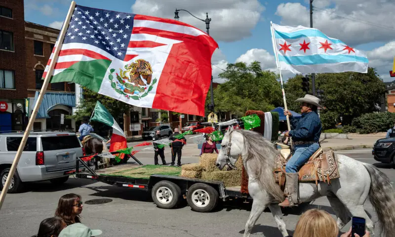 A Mexican-American flag flies as a parade participant on horseback flies a city of Chicago flag while Chicago’s Mexican community proceeds with a Mexican Independence Day parade after US President Donald Trump ordered increased federal law enforcement presence to assist in crime prevention, in Chicago, Illinois. – Reuters A Mexican-American flag flies as a parade participant on horseback flies a city of Chicago flag while Chicago’s Mexican community proceeds with a Mexican Independence Day parade after US President Donald Trump ordered increased federal law enforcement presence to assist in crime prevention, in Chicago, Illinois. – Reuters