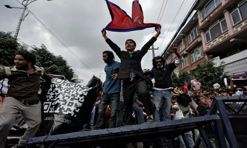 Demonstrators shout slogans as they stand on a barricade during a protest against corruption and the government’s decision to block several social media platforms, in Kathmandu, Nepal September 8, 2025. REUTERS Demonstrators shout slogans as they stand on a barricade during a protest against corruption and the government’s decision to block several social media platforms, in Kathmandu, Nepal September 8, 2025. REUTERS
