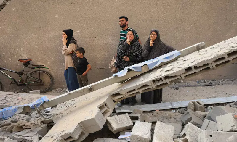 Palestinians inspect the damage at the site of Israeli strikes that destroyed Al Jundi Al Majhoul residential tower in Gaza City. – Reuters Palestinians inspect the damage at the site of Israeli strikes that destroyed Al Jundi Al Majhoul residential tower in Gaza City. – Reuters