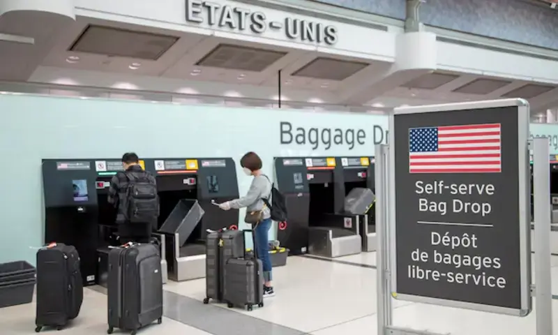 Passengers drop their bags off before walking towards the gates for U.S. travel at Toronto Pearson International Airport in Toronto, Ontario, Canada June 23, 2020. REUTERS Passengers drop their bags off before walking towards the gates for U.S. travel at Toronto Pearson International Airport in Toronto, Ontario, Canada June 23, 2020. REUTERS