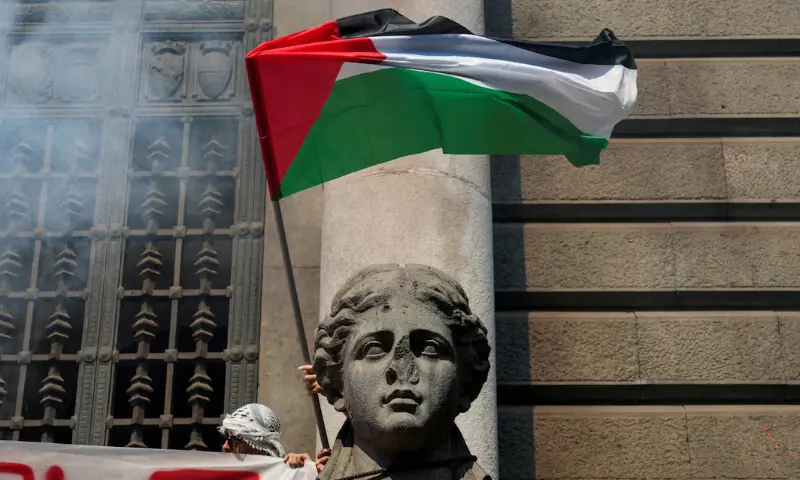 A demonstrator waves a Palestinian flag near a statue, during a nationwide strike called by the USB union, with the slogan “Let’s Block Everything”, in solidarity with Gaza and calling for a halt to arms shipments to Israel, in Naples, Italy, September 22, 2025. REUTERS A demonstrator waves a Palestinian flag near a statue, during a nationwide strike called by the USB union, with the slogan “Let’s Block Everything”, in solidarity with Gaza and calling for a halt to arms shipments to Israel, in Naples, Italy, September 22, 2025. REUTERS