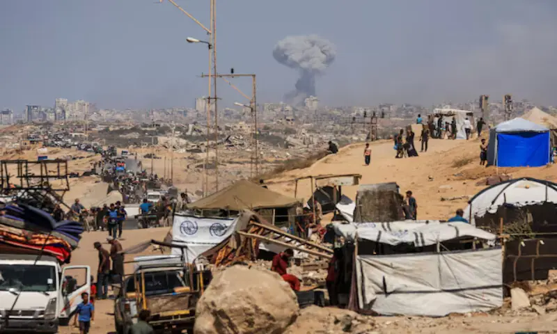 Smoke rises from an Israeli strike as displaced Palestinians, fleeing northern Gaza due to an Israeli military operation, move southward in the central Gaza Strip. – Reuters Smoke rises from an Israeli strike as displaced Palestinians, fleeing northern Gaza due to an Israeli military operation, move southward in the central Gaza Strip. – Reuters