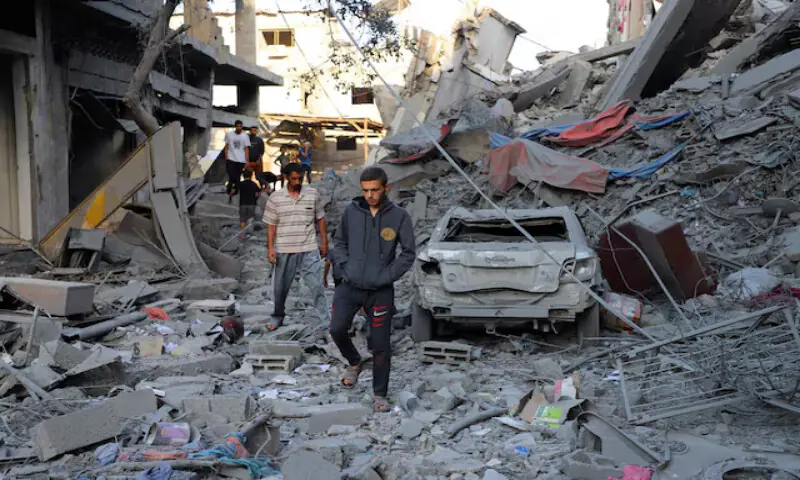 Palestinians inspect the site of Israeli strikes on houses at Shati (Beach) refugee camp in Gaza City. – Reuters Palestinians inspect the site of Israeli strikes on houses at Shati (Beach) refugee camp in Gaza City. – Reuters