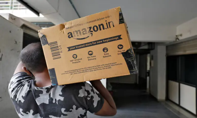 A delivery worker of Amazon carries a packet to deliver it to a customer at a residential apartment in Ahmedabad, India. – Reuters A delivery worker of Amazon carries a packet to deliver it to a customer at a residential apartment in Ahmedabad, India. – Reuters