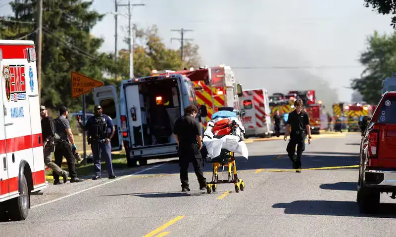 Emergency personnel work at the scene of a shooting which took place at the Church of Jesus Christ of Latter-day Saints, according to police, in Grand Blanc, Michigan, U.S., September 28, 2025. REUTERS